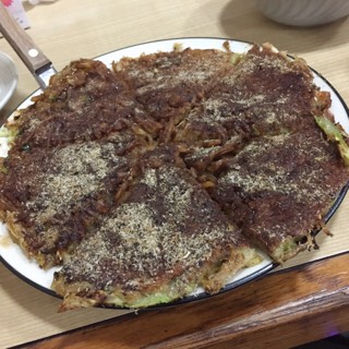 �߂���